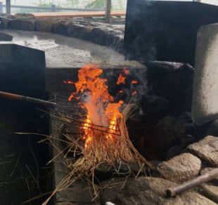Grill like a Katsuo Meister: Traditional Kochi fishermen's-style wara-yaki katsuo tataki (straw-seared skipjack tuna) is seared on a long garden fork over an open-air fireplace. | ROBBIE SWINNERTON