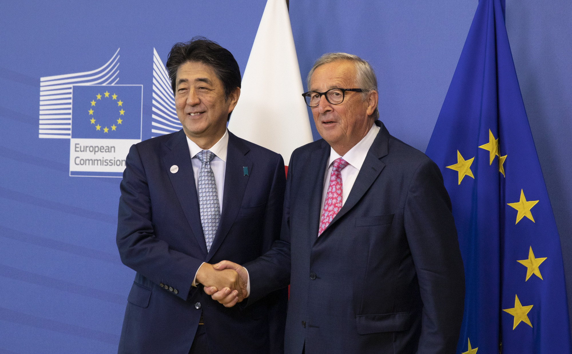 Prime Minister Shinzo Abe is greeted by European Commission President Jean-Claude Juncker prior to a meeting at EU headquarters in Brussels on Sept. 27. The new Japan-EU agreement is an important move in the right direction to meet China's international challenges. | AP