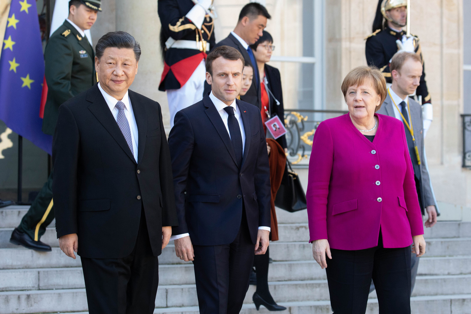 Chinese President Xi Jinping poses for the press with his French and German counterparts Emmanuel Macron and Angela Merkel at Elysee Palace in Paris on March 26. | BLOOMBERG