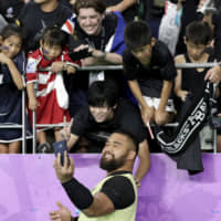New Zealand\'s Nepo Laulala poses for a selfie with fans after the All Blacks\' win over Canada on Wednesday in Oita. | AP