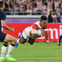 Japan wing Kotaro Matsushima scores a try in the first half against Pool A foe Scotland in a Rugby World Cup match on Sunday at International Stadium Yokohama. | AFP-JIJI
