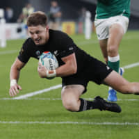 The All Blacks\' Beauden Barrett scores their third try against Ireland during Saturday\'s Rugby World Cup quarterfinal match at Tokyo Stadium. New Zealand won 46-14. | REUTERS