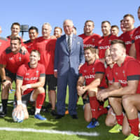Wales players and coaches pose with Prince Charles, who visited Japan this week to attend the enthronement ceremony of Emperor Naruhito, on Wednesday in Tokyo. | KYODO