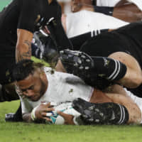 England\'s Manu Tuilagi scores the match\'s first try in the opening minute against New Zealand in the semifinals of the Rugby World Cup on Saturday at International Stadium Yokohama. England won 19-7. | REUTERS