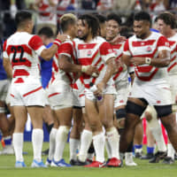 Japan players celebrate after their Rugby World Cup Pool A win over Samoa on Saturday at City of Toyota Stadium. | AP