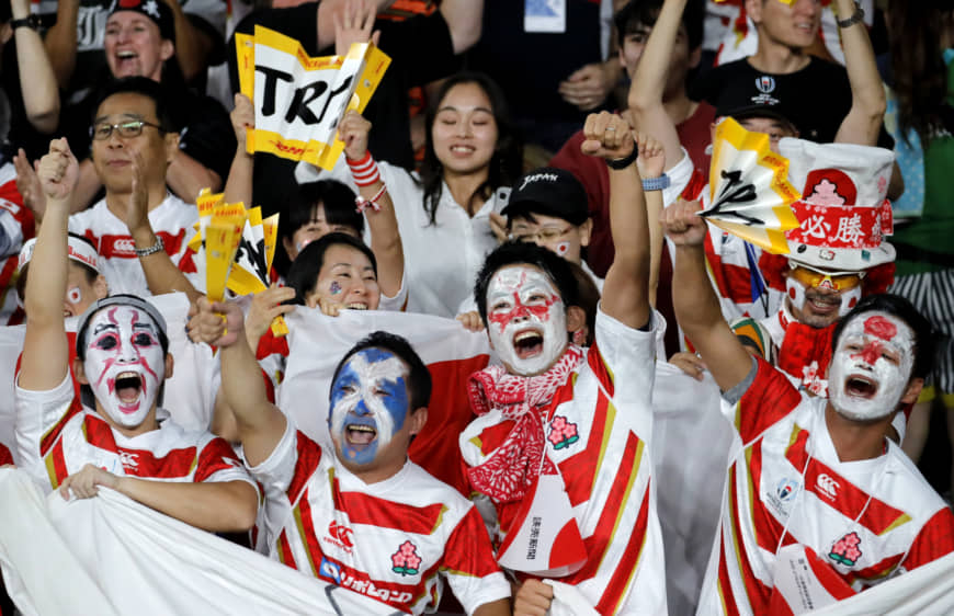 Japan fans celebrate after Kotaro Matsushima scored the team's first try on Sunday. | AP