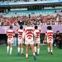 Japan\'s players return to the locker room after Sunday\'s Rugby World Cup quarterfinal at Tokyo Stadium. | REUTERS