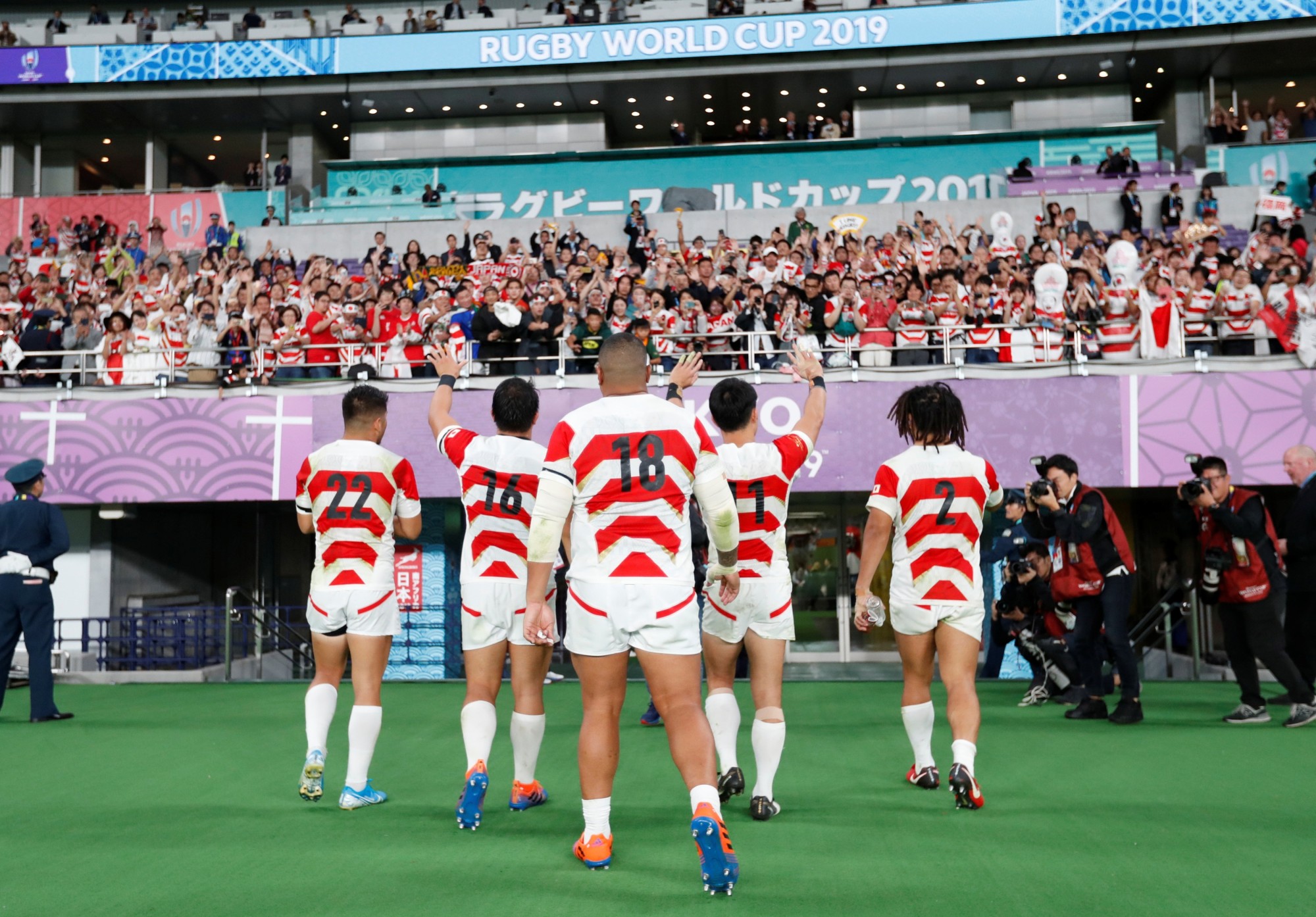 Japan's players return to the locker room after Sunday's Rugby World Cup quarterfinal at Tokyo Stadium. | REUTERS