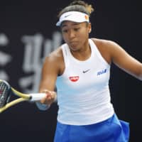 Naomi Osaka smacks a forehand return to Andrea Petkovic in a China Open women\'s second-round match on Tuesday in Beijing. | KYODO