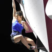 Miho Nonaka reacts after climbing up a wall in the women\'s bouldering final at the inaugural World Beach Games in Doha, Qatar, on Monday. Nonaka captured the gold medal in the event. | KYODO