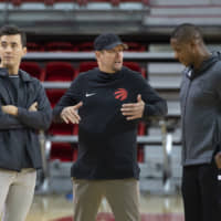 Toronto Raptors head coach Nick Nurse (center) gestures while talking to team president Masai Ujiri (right) as general manager Bobby Webster looks on during an Oct. 1 practice session at Laval University in Quebec City, Quebec. | AP