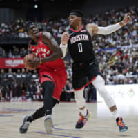Toronto Pascal Siakam drives against Houston\'s Russell Westbrook in NBA preseason action in Saitama on Tuesday night. | AP