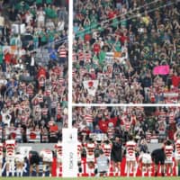 Japan\'s players applaud supporters at Tokyo Stadium after the team\'s 26-3 defeat to South Africa on Sunday in the quarterfinals of the Rugby World Cup. | KYODO