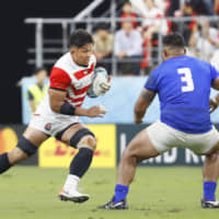 Kazuki Himeno carries the ball against Samoa during the World Cup Pool A match on Saturday at City of Toyota Stadium in Aichi Prefecture.  | KYODO