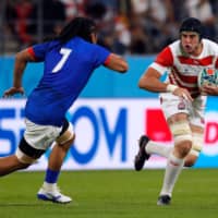 The Brave Blossoms\' Wimpie van der Walt runs to evade Samoa\'s TJ Ioane on Saturday. | AFP-JIJI