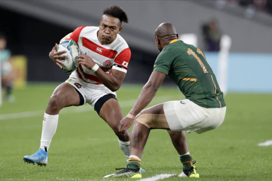Japan's Kotaro Matsushima carries the ball against South Africa's Makazole in their Rugby World Cup quarterfinal match on Sunday night. | AP