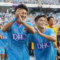 Sagan Tosu\'s Yohei Toyoda (left) and Takashi Kanai celebrate after the team\'s 2-1 home victory over FC Tokyo on Saturday. | KYODO