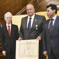 Mohamed Ali Rashwan (center), silver medalist in the men\'s open class category at the 1984 Los Angeles Olympics, attends a ceremony to receive Japan\'s spring 2019 Order of the Rising Sun decoration in Cairo on Monday. | KYODO