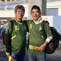 Yasunori Katsukura (right) and Hitoshi Kikuchi decided to support South Africa during the semifinals of the Rugby World Cup on Sunday in Yokohama. | KAZ NAGATSUKA