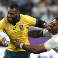 Australia\'s Samu Kerevi tries to break a tackle during the Rugby World Cup quarterfinal match against England at Oita Stadium on Saturday. | REUTERS