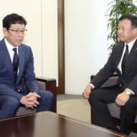 Fighters manager Hideki Kuriyama (left) meets with team owner Yoshihide Hata on Wednesday in Tokyo. | KYODO