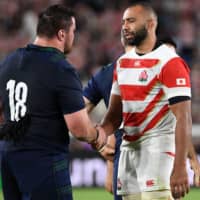 Japan captain Michael Leitch (right) shakes hands with Scotland prop Zander Fagerson after their Rugby World Cup Pool A match on Sunday in Yokohama. | AFP-JIJI