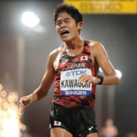 Yuki Kawauchi crosses the finish line in the men\'s marathon at the IAAF World Athletics Championships in Doha on Oct. 6. | REUTERS