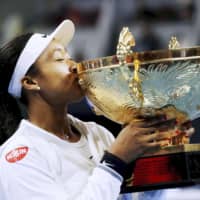 Naomi Osaka kisses the trophy after defeating Australia\'s Ash Barty to win the women\'s final of the China Open on Sunday in Beijing. | REUTERS