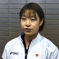 Nozomi Okuhara speaks to reporters at Narita Airport on Tuesday. | KYODO