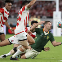 South Africa\'s Willie Le Roux (right) is chased by Japan\'s Kenki Fukuoka and Kotaro Matsushima during the Rugby World Cup quarterfinal match at Tokyo Stadium in Tokyo Sunday. | AP
