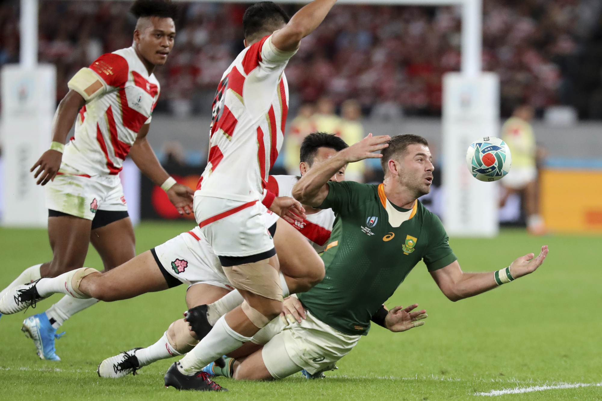 South Africa's Willie Le Roux (right) is chased by Japan's Kenki Fukuoka and Kotaro Matsushima during the Rugby World Cup quarterfinal match at Tokyo Stadium in Tokyo Sunday. | AP