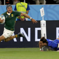 South Africa\'s Cheslin Kolbe runs past an Italy defender to score a try in a Rugby World Cup Pool B game at Shizuoka Stadium Ecopa on Friday. | AP