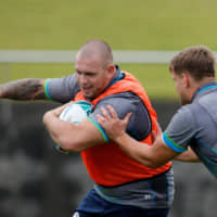 Scotland prop Gordon Reid (left) runs with the ball during a training session at Enshunada Coastal Park in Hamamatsu, Shizuoka, Prefecture, on Monday. | AFP-JIJI