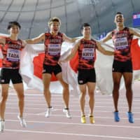 The Japanese men\'s 4x100-meter relay team of (from left) Shuhei Tada, Kirara Shiraishi, Yoshihide Kiryu and Abdul Hakim Sani Brown pose after finishing third at the world athletics championships on Saturday in Doha. | KYODO