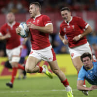 Wales\' Gareth Davies scores his team\'s final try against Uruguay in a Rugby World Cup Pool D game at Kumamoto Stadium on Sunday. Wales defeated Uruguay 35-13. | AP
