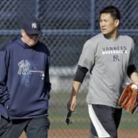 Yankees pitching coach Larry Rothschild (left), seen walking with hurler Masahiro Tanaka in February 2014 at spring training, was fired after nine seasons on Monday. | AP