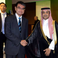 Ambassador of Saudi Arabia Nayef Mrzouq Alfahadi (right) welcomes Defense Minister Taro Kono (left) during a reception celebrating the 89th national day of the Kingdom of Saudi Arabia at The Okura Tokyo on Sept. 26. | YOSHIAKI MIURA