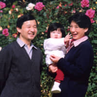 Crown Prince Naruhito and Crown Princess Masako with their daughter, Princess Aiko, on the grounds of the Akasaka Estate in Tokyo on Nov. 19, 2002. | IMPERIAL HOUSEHOLD AGENCY / VIA KYODO