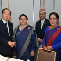 President of Nepal Bidya Devi Bhandari (second from left) with President of the Japan-Nepal Parliamentary Friendship League Toshihiro Nikai (left) and Nepal Ambassador Prativa Rana (right) during a welcome reception at the Okura Tokyo on Oct. 21. | YOSHIAKI MIURA