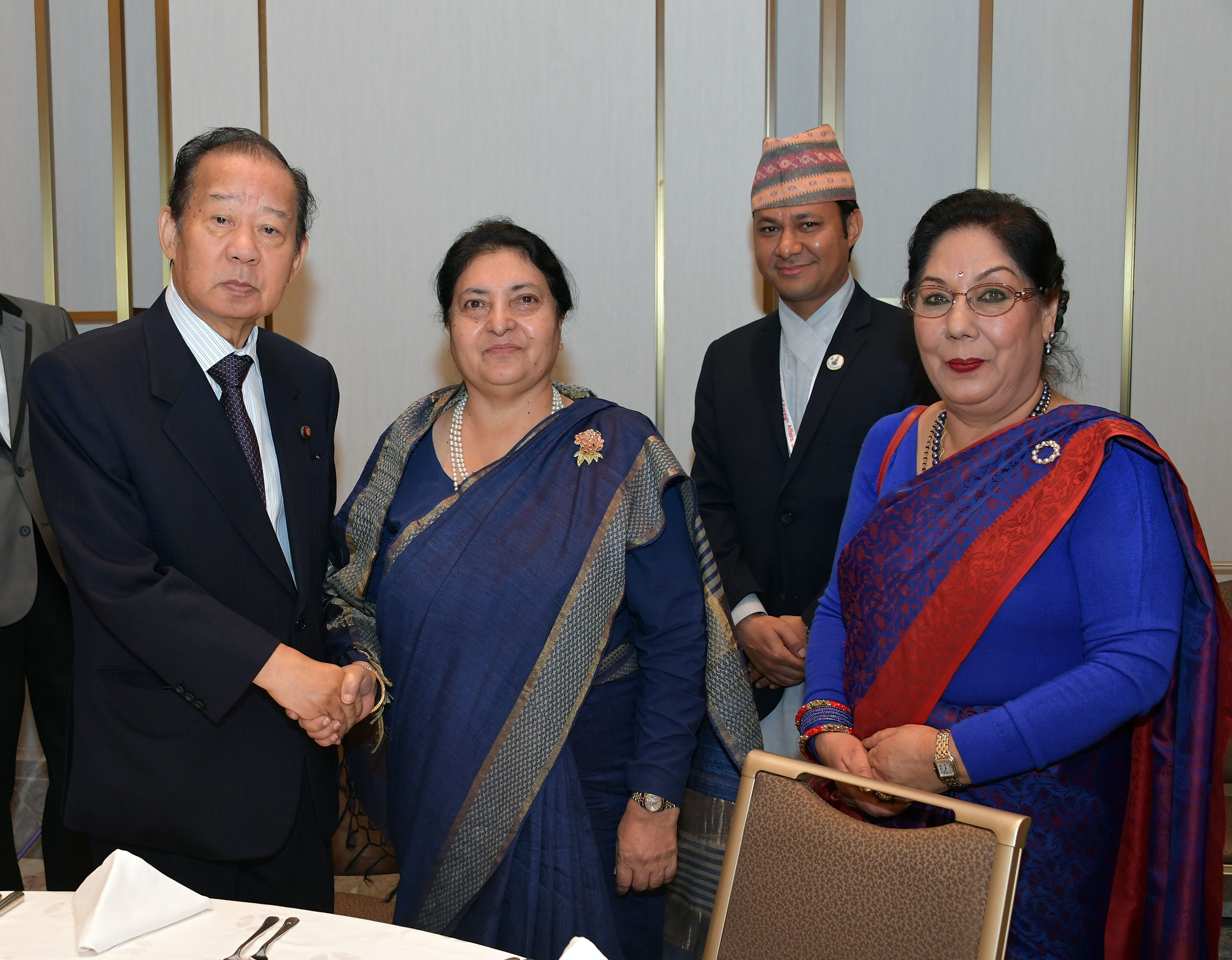 President of Nepal Bidya Devi Bhandari (second from left) with President of the Japan-Nepal Parliamentary Friendship League Toshihiro Nikai (left) and Nepal Ambassador Prativa Rana (right) during a welcome reception at the Okura Tokyo on Oct. 21. |  YOSHIAKI MIURA