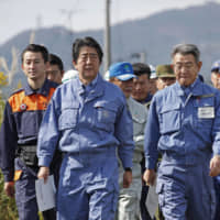 Prime Minister Shinzo Abe visits the city of Motomiya, Fukushima Prefecture,  on Thursday. The city was flooded after being hit by Typhoon Hagibis over the weekend. | KYODO