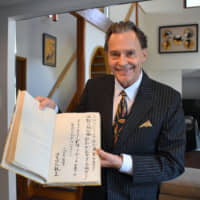 Andrew B. Arkley,  an Australian friend of Emperor Naruhito, holds a handwritten poem and message from the emperor in 1976 at his home in Yokohama on Sept. 19 . | SATOKO KAWASAKI