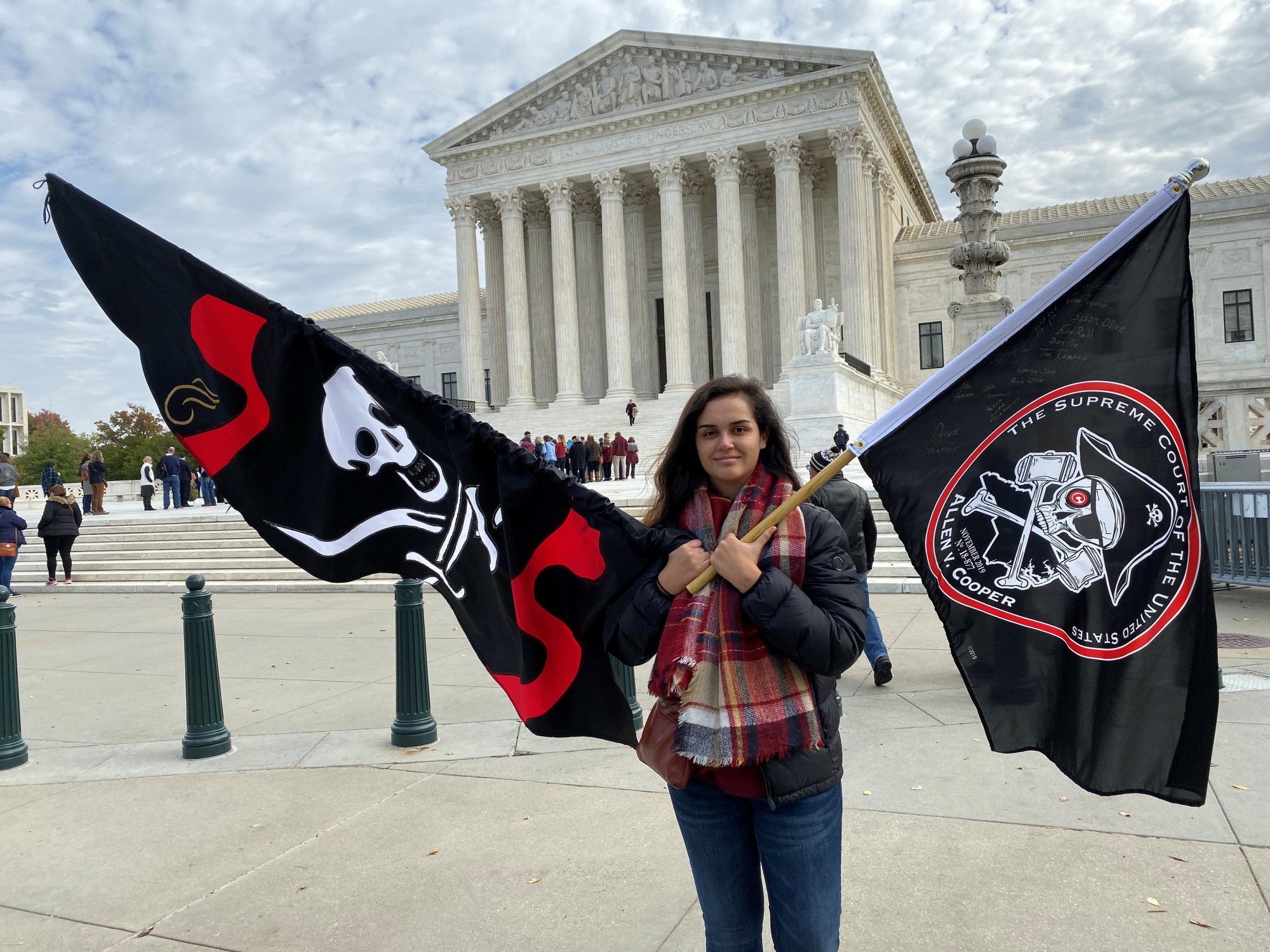 Christina Burnham holds pirate-themed flags in front of the Supreme Court in Washington NTuesday in support of her uncle, Frederick Allen, a filmmaker whose appeal in a copyright lawsuit over the use of his footage of Blackbeard's shipwreck is being heard by the justices. | REUTERS