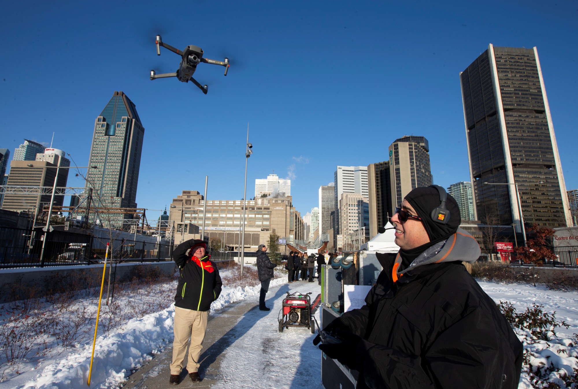 A drone operator flies his drone as Chinese drone maker DJI holds a demonstration to display an app that tracks a drone's registration and owner, in Montreal, Quebec, Wednesday. | REUTERS