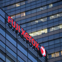 The logo of Fuji Xerox Co., a joint venture by Fujifilm Holdings Corp. and Xerox Corp., is displayed outside the building housing the company\'s headquarters in January 2018. Fujifilm plans to turn the firm into a wholly owned subsidiary. | BLOOMBERG