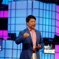 Huawei\'s rotating chairman, Guo Ping, speaks during the Web Summit in Lisbon Monday. | REUTERS