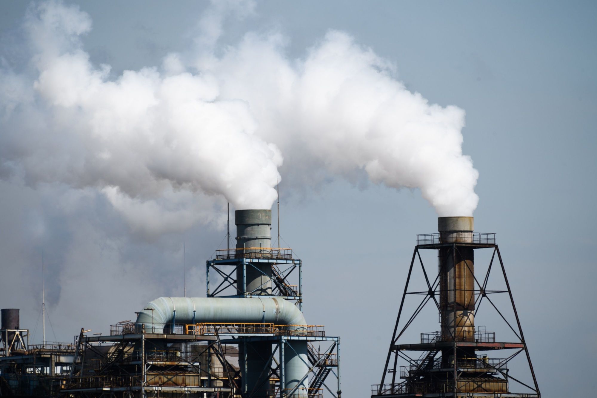 Steam rises from stacks in the Keihin industrial area of Kawasaki in September. | BLOOMBERG