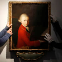 Workers install a portrait due to be sold at auction by Christie\'s that depicts composer Wolfgang Amadeus Mozart as a teenager, painted in January 1770, and attributed to Veronese master Gaimbettino Cignaroli, in Paris Tuesday. | REUTERS