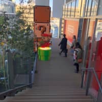 Visitors pass a Super Mario statue installed on the walkway outside Shibuya Parco on Thursday. | KAZUAKI NAGATA
