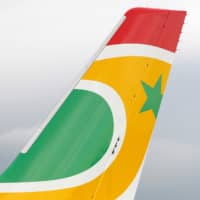 The logo of Air Senegal SA is pictured on the tail of an airplane parked at the aircraft builder\'s headquarters of Airbus in Colomiers near Toulouse, France, Friday. | REUTERS